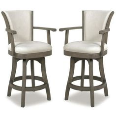 pair of swivel barstools with white upholstered backrests