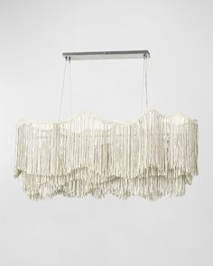 a white chandelier with fringes hanging from the ceiling