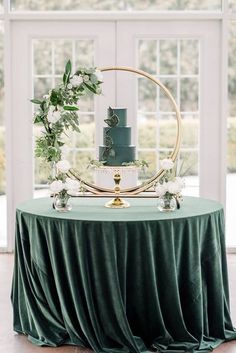 a green wedding cake sitting on top of a table