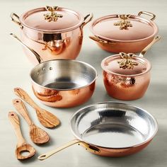 copper pots and pans with wooden utensils