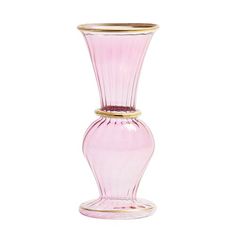 a pink glass vase sitting on top of a white table