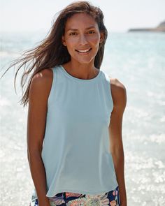 A ready-for-anything rashguard, to wear as a cover-up with a bikini top or as a tank with a sports bra. Crafted in a UPF 50+ swim fabric made mostly from recycled plastic bottles, with a breezy scalloped split back that can be tied for a more fitted silhouette.  By Carve Designs. Crew neckline. Sleeveless. UPF 50+ sun protection. Fitted Tops For Water Sports In Summer, Summer Moisture-wicking Tops For Water Sports, Moisture-wicking Tops For Water Sports In Summer, Blue Beach Tops With Upf 50+, Blue 4-way Stretch Tops For Summer, Blue Tops For Beach With Upf 50+, Stretch Top For Water Sports In Summer, Stretch Tops With Uv Protection For Summer, Summer Tops With Upf 50+ For Poolside