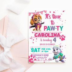 a paw patrol birthday party with pink and white paper on the table next to it's envelope