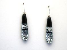 "Dichroic glass earrings. Silver sparkle on black glass. We hand make them here on Maui. They measure 1 1/4\" below the ear wire. We mail them in a white gift box with an Aloha card describing our work. Shipping stays at $4.99 for multiples of our work." Black Czech Glass Jewelry With Ear Wire, Fusing Glas, Dichroic Glass Earrings, Fused Glass Earrings, Glass Jewellery, Fused Glass Jewelry, Glass Fusing, Silver Sparkle, Dichroic Glass