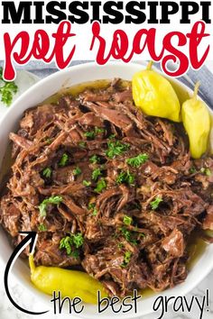 a white bowl filled with shredded beef and garnished with parsley on top