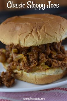 a close up of a sandwich on a plate with the words classic sloppy joes