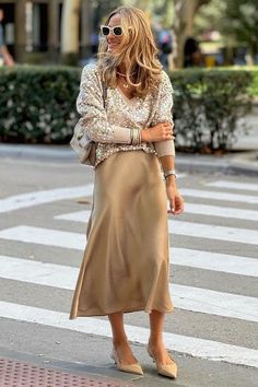 If you need a little extra help styling sequins, here are 10 ways to wear a sequin top, with plenty of chic and casual outfits that are perfect for the Christmas party season! We especially love this look with a champagne gold satin midi skirt – it's great for New Year's Eve as well as any other casual holiday celebration during the fall and winter. Pullover Mode, Rock Outfit, Party Dress Long Sleeve, Skirt Midi, Puff Sleeve Dresses, Satin Skirt, Women Sleeve, Loose Sweater, Party Dress Long