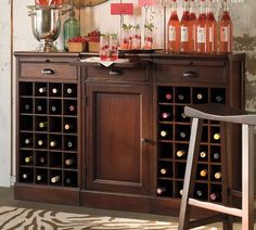 a wooden cabinet with wine bottles on it