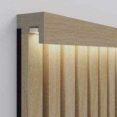 a close up of a wooden headboard with light coming through the wood slats