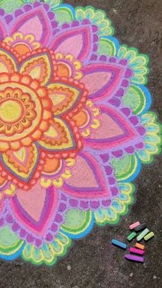 a colorful drawing on the ground with crayons