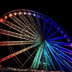 a large ferris wheel lit up at night