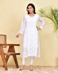 Our White Chikankari Kotadoria Straight Kurta is crafted from high-quality cotton for superior comfort and fit. It features a relaxed fit that's perfect for everyday wear. Experience the utmost comfort without compromising an elegant style! Features: Long kurta in Pure soft Kotadoria cotton fabric Hand-embroidered with Chikankari  work Our model is wearing size S and is 5 feet 6 inches tall. Length: Kurta - 47" inches |  Fabric: Pure Soft Cotton Embroidery : Chikankari ghasspatti work Color: White Print : Floral Print Matching White Pant or sharara is avl Inner or white Cotton Slip is avl. Pls message if you required. Garment-Care We recommend to dry clean only. Do not soak and scrub the product and dry it in shade. Do not iron on embellishments. Unstitched Long Sleeve Cutwork Kurta, Long Sleeve Kurta With Cutwork For Eid, Traditional Long Sleeve Kurta With Cutwork, White Long Kurta With Cutdana, Traditional Long Sleeve Cutwork Wear For Diwali, Long Sleeve Traditional Wear With Cutwork For Diwali, Eid Cutwork Straight Kurta, Diwali Traditional Wear With Cutwork And Long Sleeves, White Long Kurta With Self Design