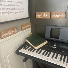 a piano with a book sitting on top of it next to a sign that says congratulations