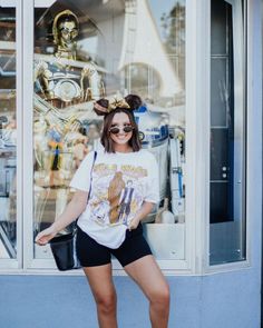 a woman standing in front of a store window