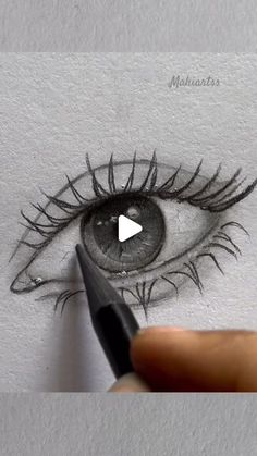 someone is drawing an eye with a marker