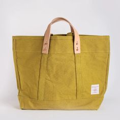 Constructed from custom-dyed 18oz cotton canvas and copper hardware, the East-West Tote converts from handheld to shoulder bag via detachable leather handles. Once the handles are removed, the tote is washable (see care instructions below). The Small size is a perfect day bag, and can easily carry your laptop, a sweater and lunch. Sturdy 100% Cotton CanvasLeather Handles (Detachable)Cotton Webbing HandlesCopper Collar Buttons and Rivets 13”H x 5”D x 18”WLeather Handle Drop: 4"Webbing Handle Drop Cork Bags, Copper Hardware, Overnight Travel Bag, Cork Bag, Pocket Notes, Bucket Tote, Multipurpose Bag, Bag Ideas, A Perfect Day