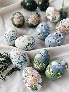 an arrangement of painted eggs on a table