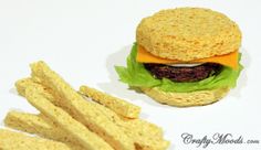 a hamburger and some french fries on a white table