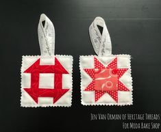 two red and white quilted tags with scissors on them, one has an ornament in the shape of a star