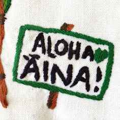 an embroidered sign with the words aloha, ahana and two carrots