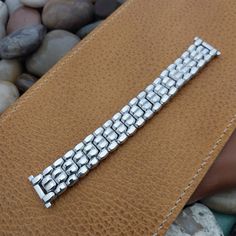 "NOS unused 1950s old-stock Speidel Cobblestone 10k white gold-filled scissor-expansion watch bracelet.    The ends are straight 3/4\" (18.8mm), you can file them to 11/16\" (17mm-18mm) or 5/8\" (just under 16mm).   Spring bars are included, remember to tell us what size you need.    The length at the spring bars is 5 1/8\" (130mm).    No removable links.    18F.17204" Elegant Silver Watch Bands With Extender, Adjustable Silver Watch Band For Formal Occasions, Formal Adjustable Silver Watch Band, Classic Silver Watch Band With Jubilee Bracelet, Timeless Silver Bracelet Strap Watch Band, Timeless Silver Watch Band With Bracelet Strap, Silver Timeless Bracelet Strap Watch Bands, Silver Polished Finish Watch Bands, Formal Stainless Steel Jubilee Bracelet Watch Bands