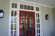 a red front door with two sidelights on the outside and one in the inside