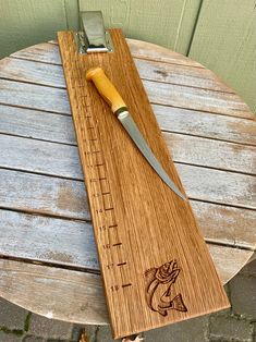 a wooden cutting board with a knife on it