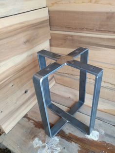 a metal object sitting on top of a wooden floor next to plywood planks