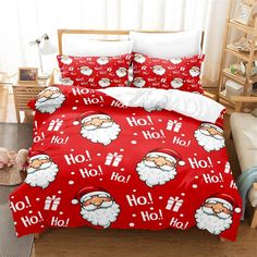 a bed with santa claus on it and red sheets that say ho ho hoo