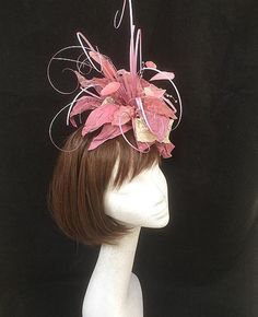 Pink and ivory flower fascinator. Wonderfully wild collection of heat treated fabrics including silks, nylons and satins teamed with synthetic grasses and scattered crystals. This design is the perfect combination of many textures and a wonderful example of how many different textile methods can be grouped together to produce the most wonderful creation. This design is set onto a fine comfort fascinator band. As with all our designs, this piece can be made exact to the image or in any colour com Whimsical Pink Headpiece With Handmade Flowers, Pink Party Headpiece With Flower Decoration, Elegant Pink Hair Accessories For Royal Ascot, Whimsical Pink Headband Fascinator, Pink Headband Fascinator For Races, Whimsical Pink Headband With Handmade Flowers, Pink Pinched Crown Headpiece For Races, Pink Headband Fascinator For Evening, Pink Evening Fascinator Headband