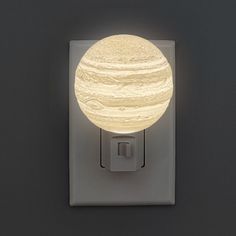 a light that is on the side of a wall with a white ball in it