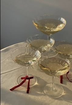 four wine glasses sitting on top of each other