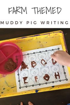 a child's hands writing on a sheet of paper with the words farm themed mudy pig writing