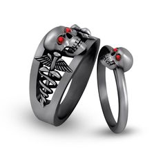 two wedding rings with skulls and red eyes