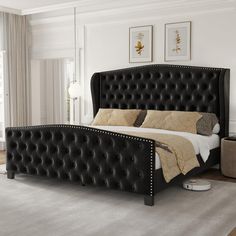 a bed with black leather headboard and foot board in a white room next to a window