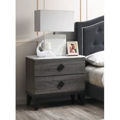 a night stand with two drawers and a lamp