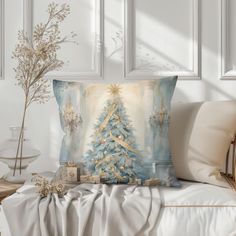 a blue christmas tree pillow sitting on top of a bed next to a vase with flowers