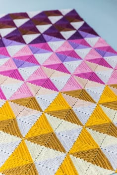 a crocheted blanket that has triangles on it