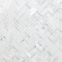 a white marble herringbone tile pattern