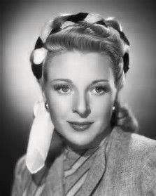 a black and white photo of a woman with long hair in a bun hairstyle