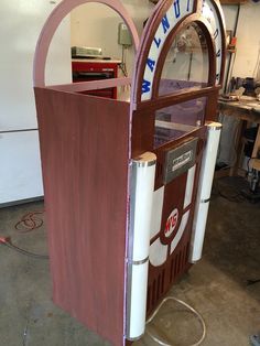 an old fashioned machine is being worked on in a shop or repair area with wood trimming