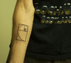 a man with a tattoo on his arm that has a golden section in the middle