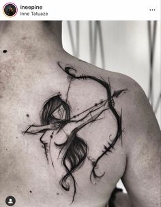 the back of a man's shoulder with an arrow and bow tattoo on it