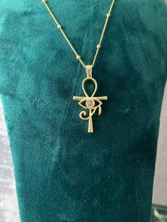 This elegant necklace features a stunning pendant combining two of the most iconic symbols of ancient Egypt: the Ankh and the Eye of Horus. Crafted from high-quality sterling silver, the pendant showcases an intricate design that includes the Eye of Horus set within the loop of the Ankh. The necklace is complemented by a delicate chain adorned with small, evenly spaced beads, adding a touch of sophistication to this unique piece. Perfect for anyone interested in Egyptian mythology or looking for Spiritual Pendant Clavicle Chain Necklace, Spiritual Pendant Necklace With Clavicle Chain, Spiritual Clavicle Chain Pendant Necklace, Spiritual Teardrop Pendant Large Jewelry, Spiritual Gold Plated Pendant Necklace, Symbolic Necklace With Large Pendant, Spiritual Gold-plated Engraved Necklaces, Spiritual Gold Necklaces In Sterling Silver, Spiritual Engraved Gold-plated Necklaces