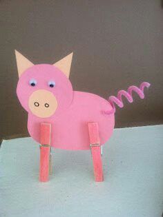 a pink pig made out of paper sitting on top of a table