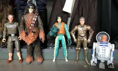 star wars action figures are lined up on a shelf