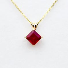 "Elevate your style with our 10K Yellow Gold Genuine Ruby 6x6mm Pendant. Featuring a stunning red ruby, this handmade pendant is the perfect embodiment of July's birthstone. The rich hue of the ruby is beautifully accentuated by the 10K yellow gold setting, creating a striking and elegant piece of jewelry. Whether it's a gift for a loved one or a special treat for yourself, this pendant is a captivating addition to any collection of red gemstone jewelry. 10K Yellow Gold Pendant Stone: Ruby 1.1ct Red Pendant Jewelry With Prong Setting, Gift Necklace With Prong Setting And Lab-created Ruby, Red Gemstone Jewelry, Maximalist Jewelry, Ruby Pendant Necklace, Ruby Necklace Pendant, Gold Chain Choker, Red Pendants, Ruby Pendant