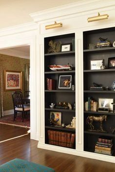 an empty bookcase in the middle of a living room