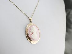 This lovely pendant is crafted in wonderful tones of yellow and pink with accents of creamy white! 10K yellow gold comprises the frame, while the cameo at the center is carved from a soft pink conch shell. This pendant does not come with the chain shown. Please feel free to contact us, we will help you find the perfect chain for your style and budget! Metal: 10K Yellow Gold, 14K Yellow Gold (bail) Gem: Cameo Gem Measurements: 30 x 24 mm, Oval Measures: 30 x 48 mm, with bail Marks: "10K" Stamped Vintage Pink Oval Pendant Jewelry, Pink Victorian Jewelry In 14k Gold, Pink Oval 14k Gold Necklace, Pink Oval 14k Stamped Jewelry, 14k Stamped Oval Pink Jewelry, Antique Pink Cameo Jewelry, Vintage 14k Gold Pink Jewelry, Vintage Pink 14k Gold Jewelry, Pink Cameo Jewelry For Formal Occasions