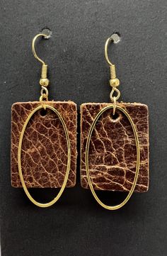 the earrings are made out of wood and metal